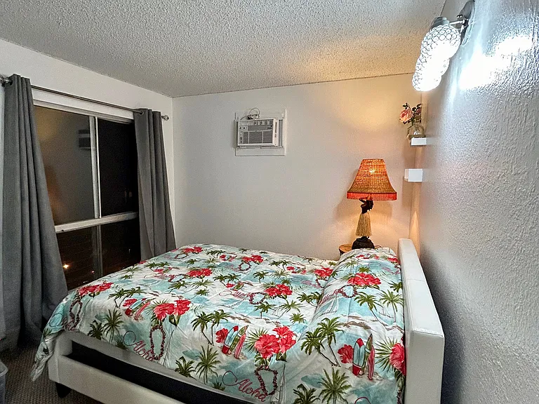 Bedroom two downstairs with ocean/mountain/pool views.