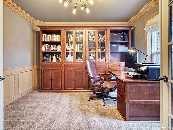 Main Floor Den/Study with French Doors custom built-in cabinets and desk