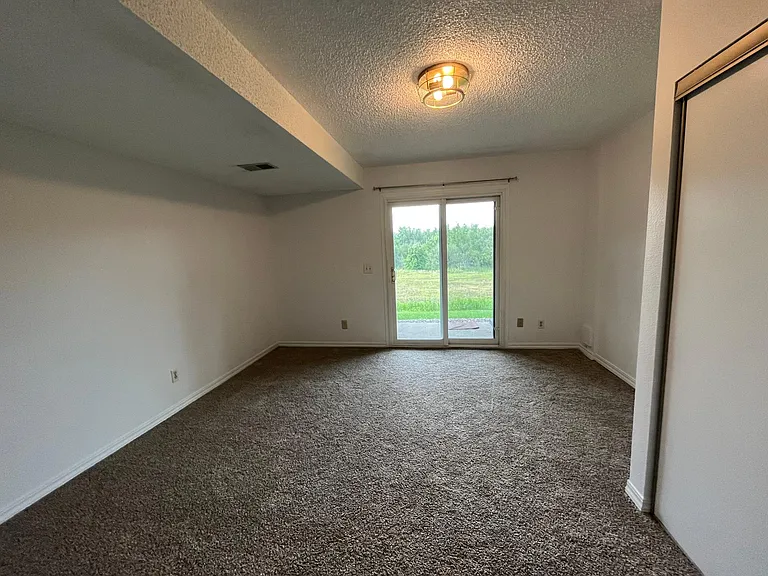 3rd bedroom in the lower level with walk out patio