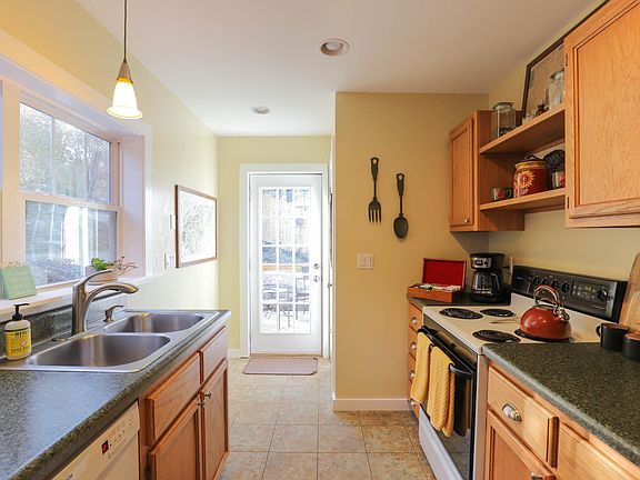 full kitchen with cups, dishes, and cooking tools