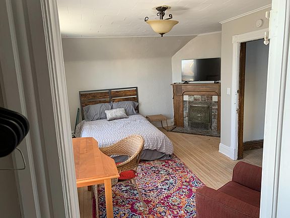 1st bedroom on the 2nd floor w/fireplace, TV, and 2 windows that have views of Lake Superior - Large room!