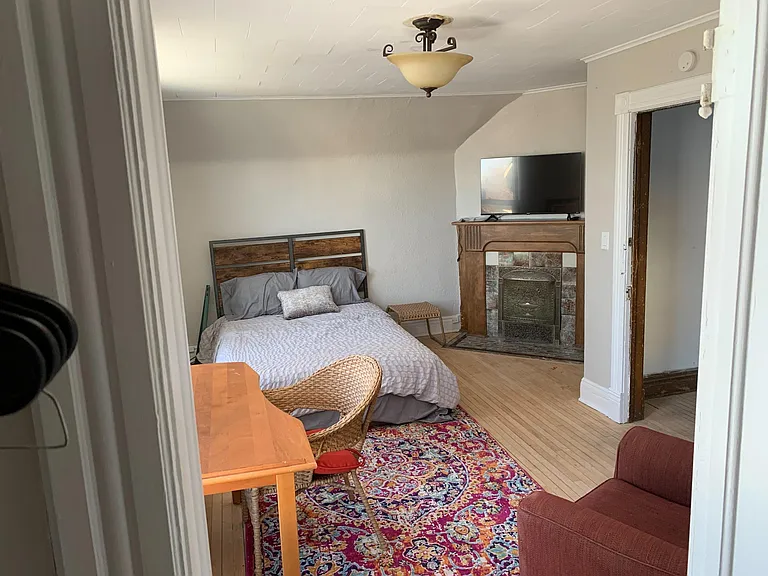 1st bedroom on the 2nd floor w/fireplace, TV, and 2 windows that have views of Lake Superior - Large room!