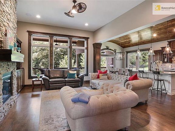 Perfect for entertaining or a quiet night at home -- this open space includes great room, stacked stone fireplace, eat-in kitchen area and the kitchen itself.  Gorgeous view of the tree line to the rear of the home.