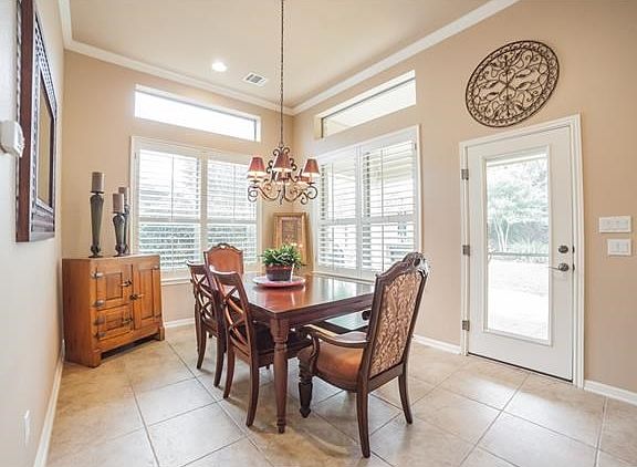 Cheerful breakfast area with plantation shutters and easy access to patio