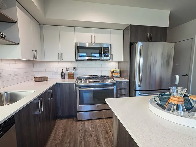 Our kitchens feature high-end finishes including stainless steel appliances and quartz countertops