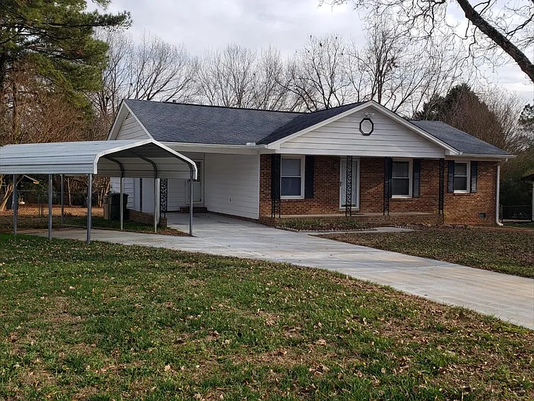 Street view. Two carports. Covered front porch