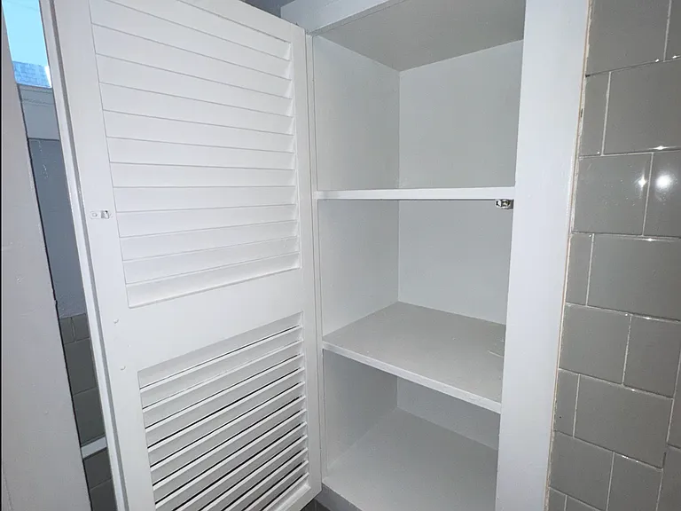 Bathroom storage rack with door