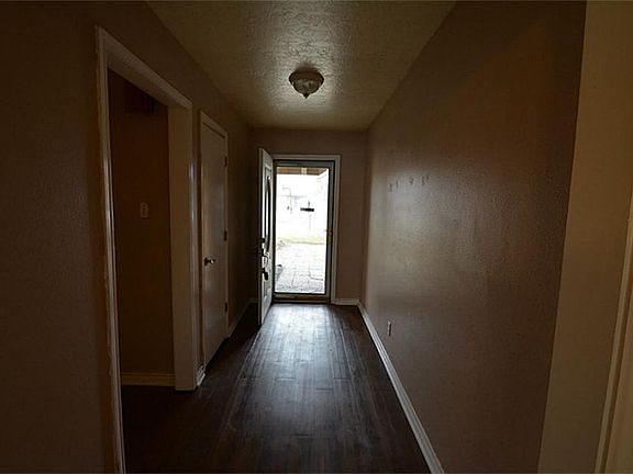 ENTRY WAY IS WIDE AND FEATURES LAMINATE FLOORING