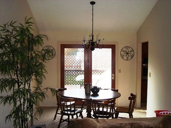 Nice dining room featuring vaulted ceiling opens to back deck.