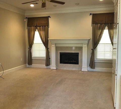 Family Room with carpet, fireplace w/gas logs, built ins