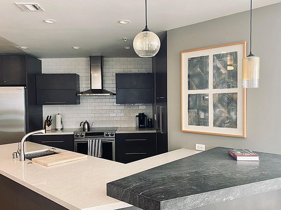 Kitchen with new stainless steel appliances; quartz and granite countertops