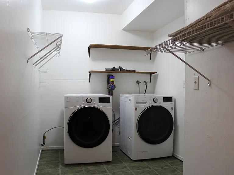 New LG washer and dryer in huge laundry/storage room (extending behind camera)