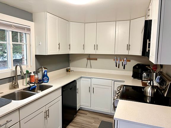 Newly remodeled kitchen with dishwasher, stove, microwave and refrigerator.