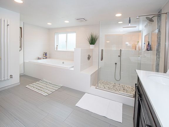 Walk in to our luxury spa experience! Double vanity, towel hooks and bars galore, walk in rain shower, 2-person heated soaking tub, and private toilet closet all make this a room you'll want to spend a lot of time in!