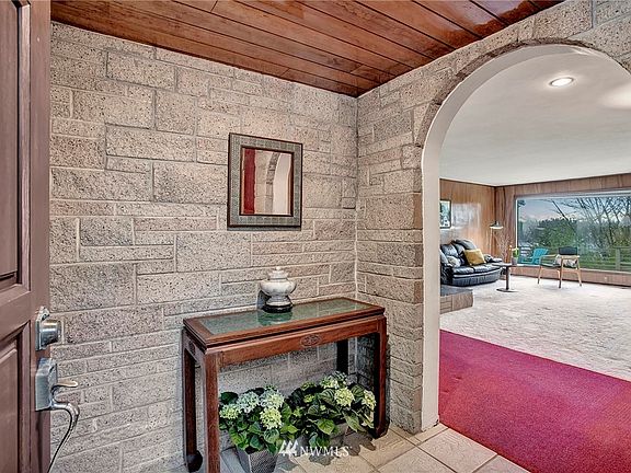 Front Entry, brick wall, tile flooring.