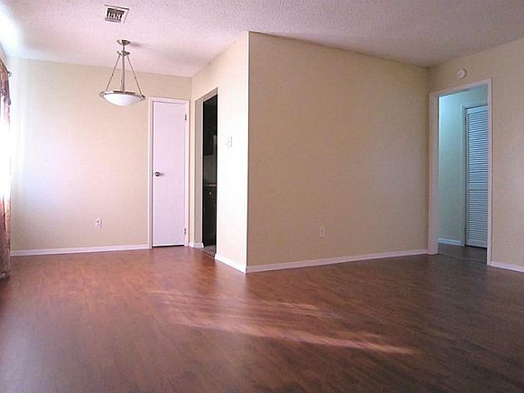  Beautiful den opens to the dining area. Note the NEW laminate wood flooring and fresh paint thru-out.