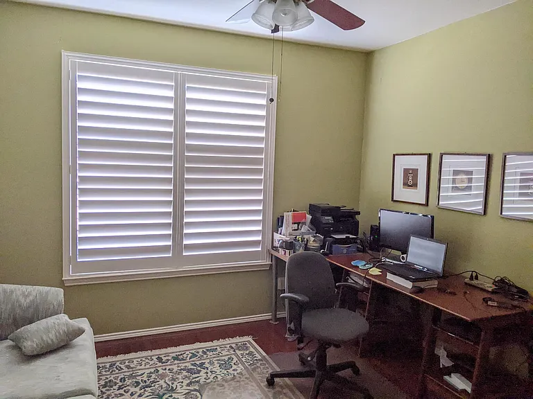 Downstairs study/4th bedroom with plantation shutter located next to bathroom. 
Couch n carpet not included