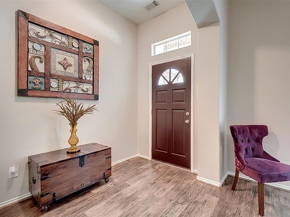 The charming entryway is bright and welcoming with wood-look tile flooring which continues throughout the main living areas.