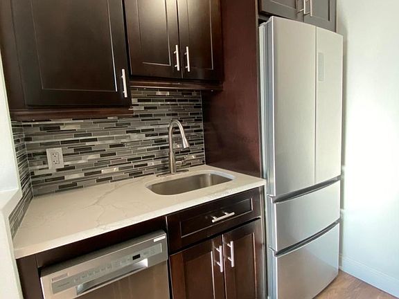 Kitchen with stainless fridge and dishwasher