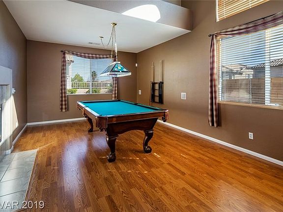 Formal dining room used as game room. Comes with pool table and light.