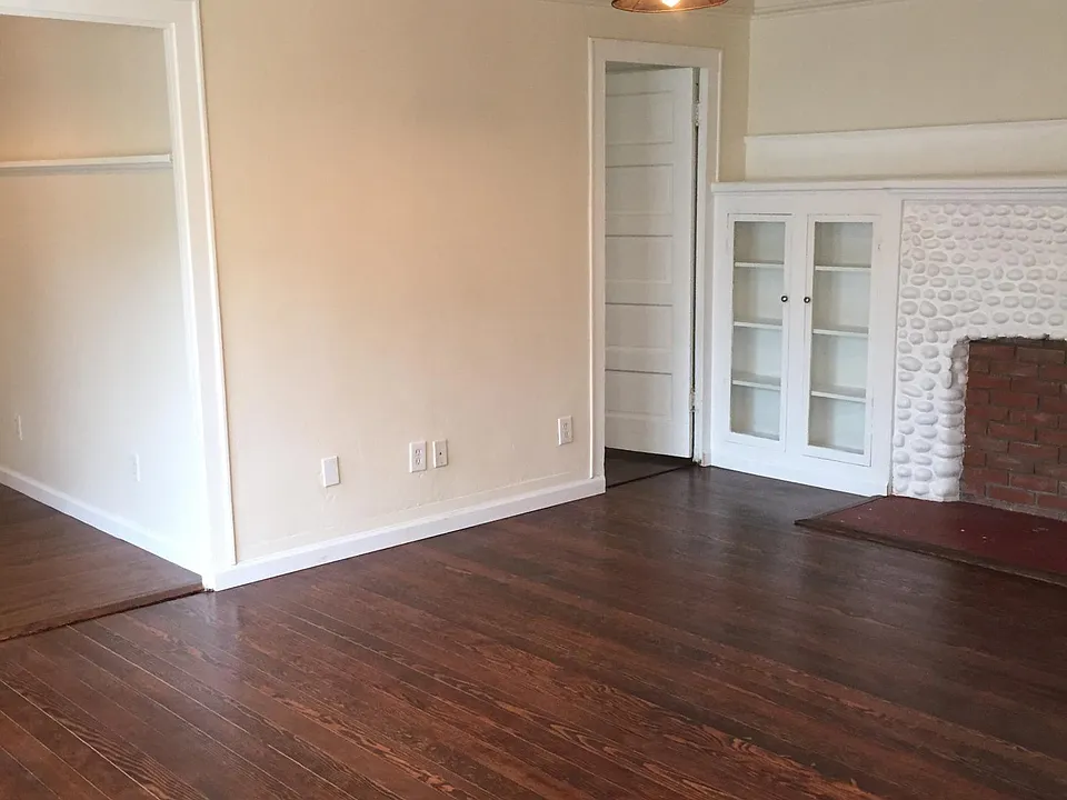 Living Room with built in cabinets, fireplace (non operable), and mantle