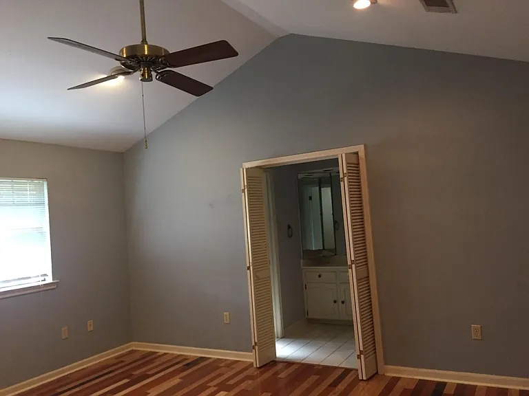 Master Bedroom with Vaulted Ceiling and Adjacent Bath