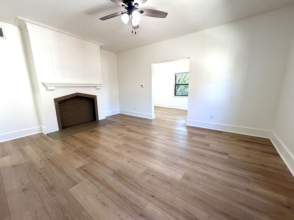 Living room with a turn of century fireplace.