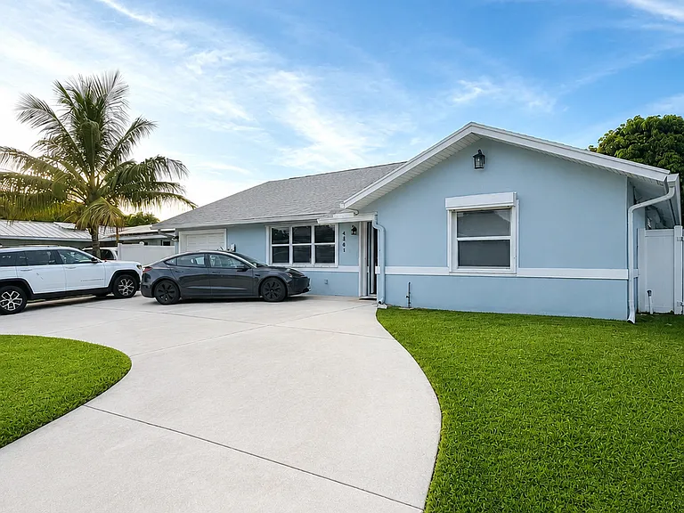 Charming Suburban Home with Tropical Flare Front - EV Ready