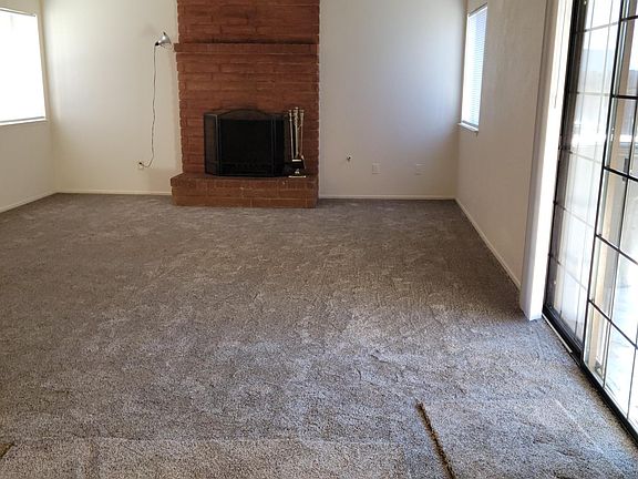 Living room, sliders to patio, windows to backyard.