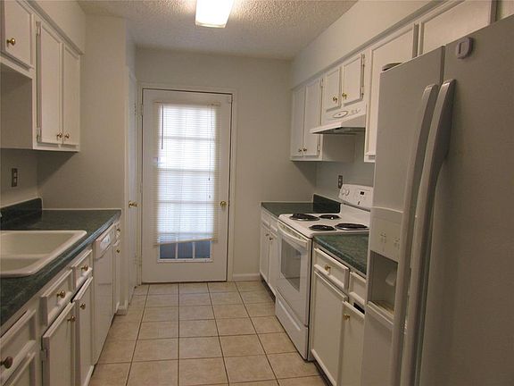 Another view of the kitchen. Refrigerator is included. Door leads to balcony where you can sit out and watch the beautiful sunsets.