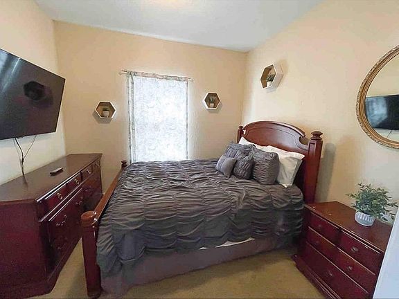 Master bedroom with TV & Haverty's furniture