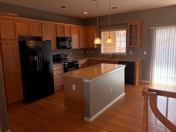 Kitchen features granite countertops and large island.