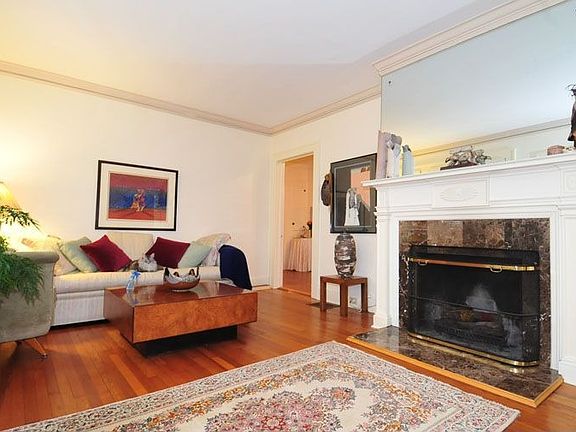 Spacious living room with wood burning fireplace and granite surround.