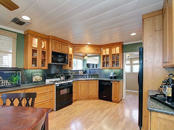 The gourmet kitchen has tongue and groove ceiling, and recessed lights