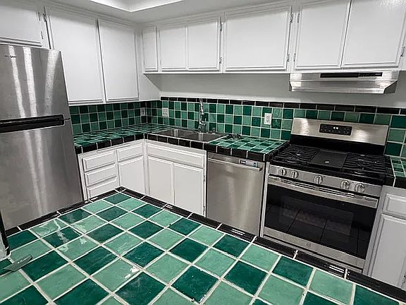 Gorgeous open kitchen with abundant storage and beautifully hand_painted Mexican tiles.