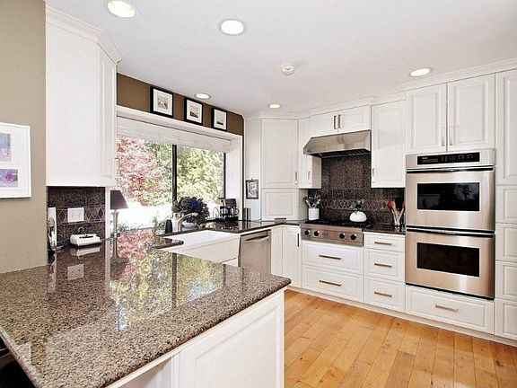 Totally remodeled kitchen with loads of pull out drawers, double oven, Viking gas cook top, farmhouse sink and granite countertops and backsplash