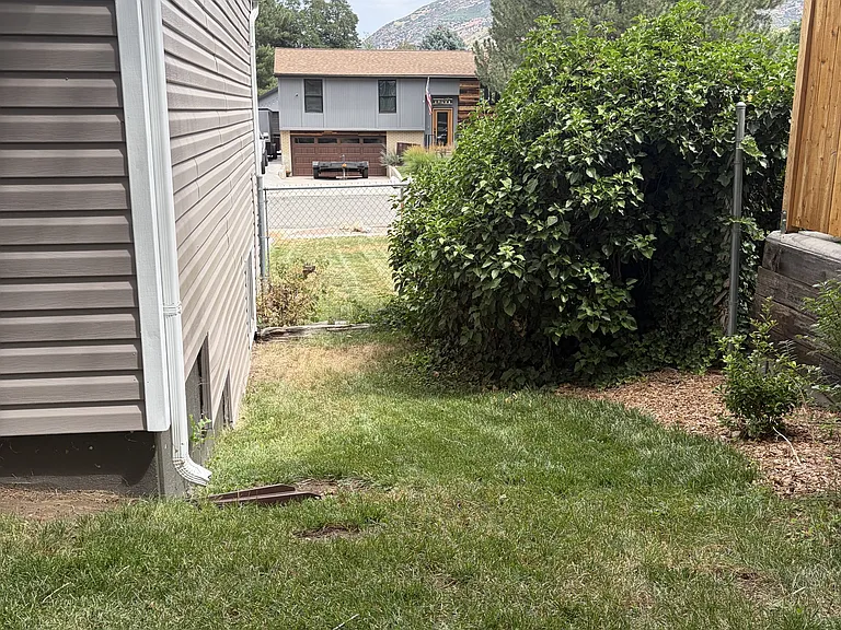 In Backyard, east side looking toward front of house.