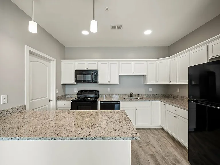 Explore this contemporary kitchen designed for modern living, featuring sleek granite surfaces.