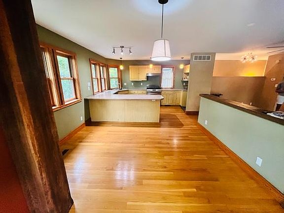 looking towards kitchen area from dining area. 
wide countertop provides work area
chairs would make for breakfast top counter