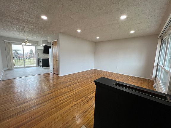 View from front door entrance into main floor living room + dining room/kitchen area