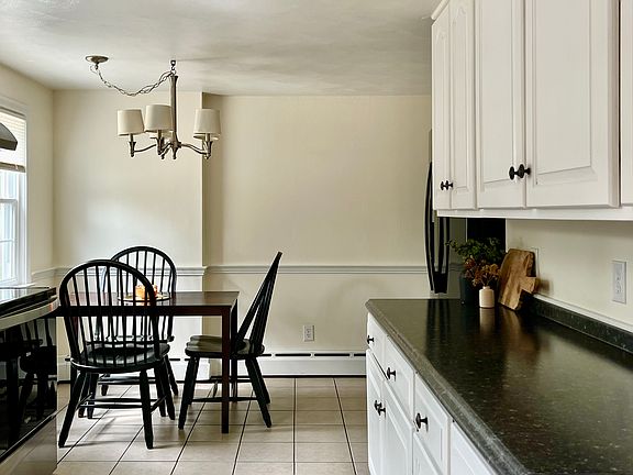 Kitchen; right side - lots of cabinet space, two door refrigerator and pull out freezer below.