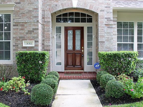 Nicely landscaped front walk in invites you in for a closer look