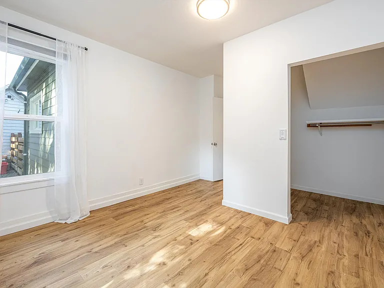 Primary bedroom on main with partial view of walk-in closet