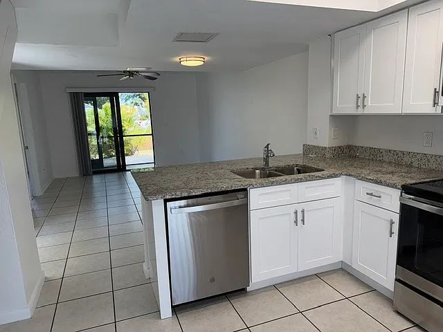 Breakfast bar, cooktop range & dishwasher, microwave, refrigerator.