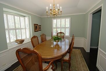 Wainscoting and Ample Windows Enhance The Formal Dining Room
