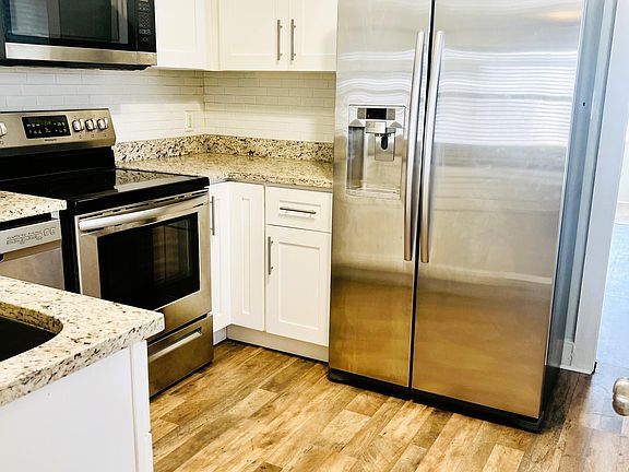 Light and Bright Kitchen with Stainless Steel appliances and Granite Counters