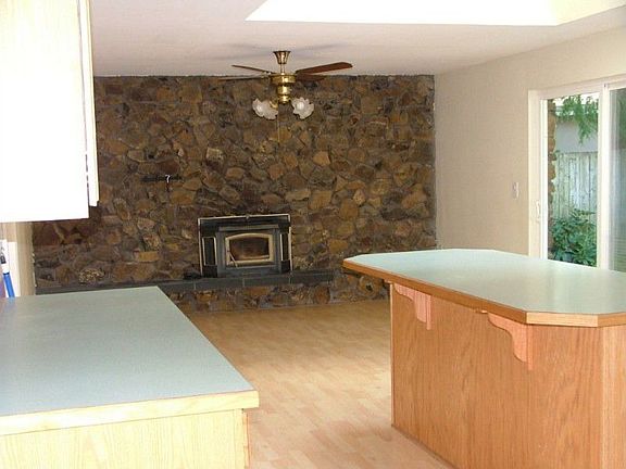 Family Room with beautiful wood stove and stone wall