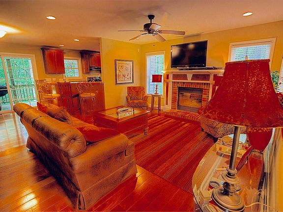 Living area open to kitchen, with cozy gas fireplace.