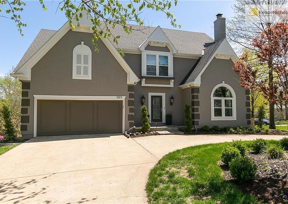 Beautiful curb appeal with this circle drive, landscaping, and 2-car attached garage