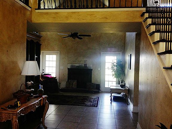 VIEW FROM ENTRY INTO COZY DEN WITH WOOD BURNING FIREPLACE